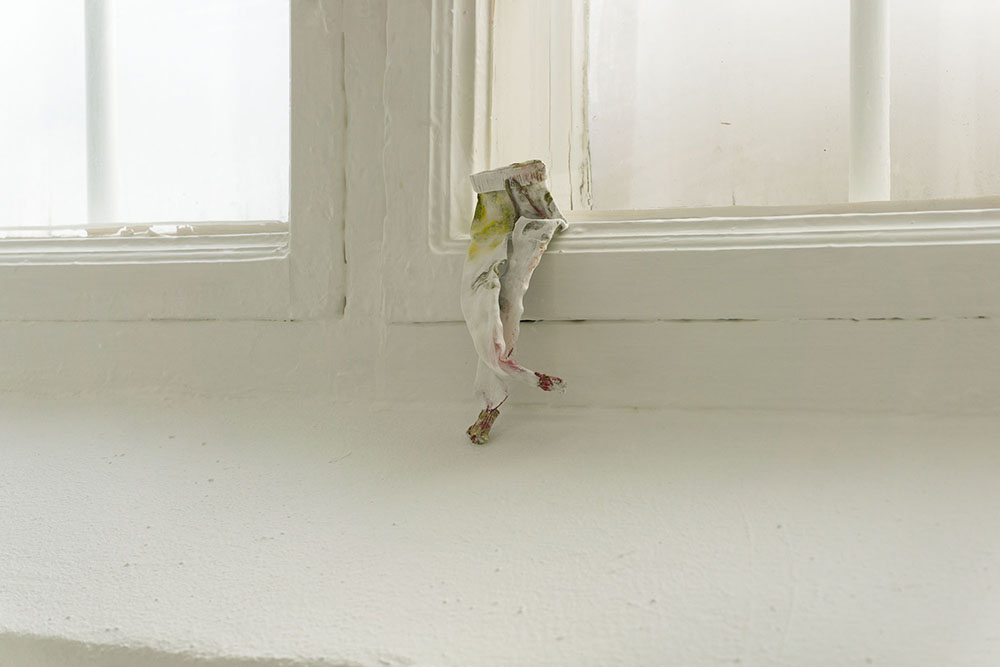 tiny sweatpants sitting on a window frame